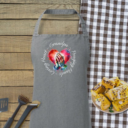 a gray apron with a picture of a hand holding a heart