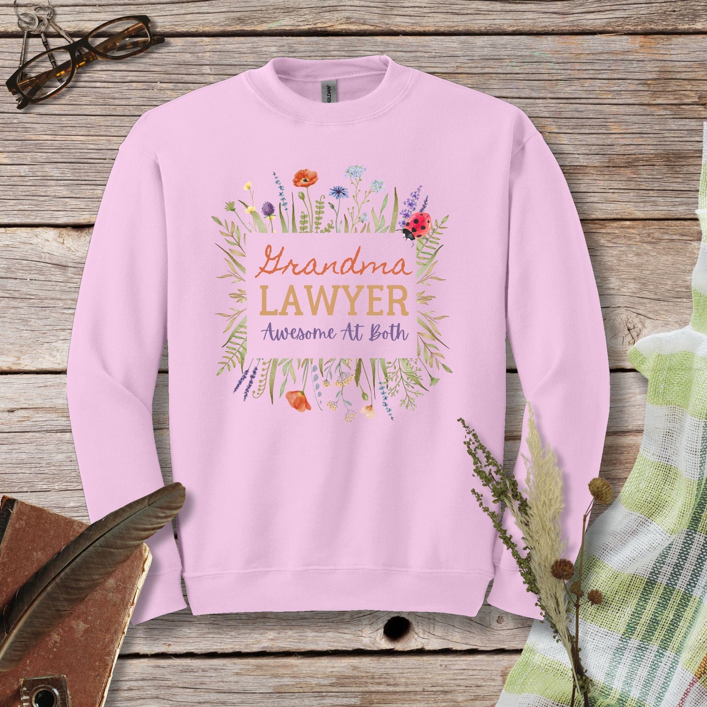 a pink sweatshirt with a floral design on it