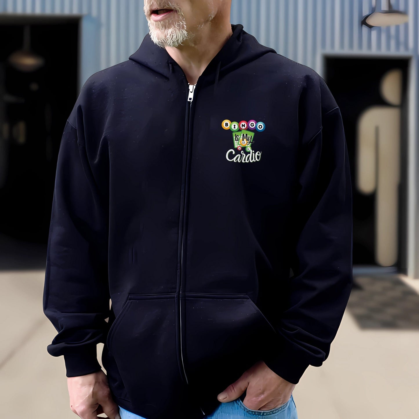 a man in a black hoodie is standing in front of a building