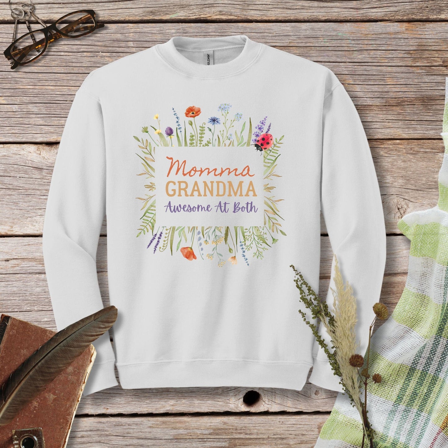 a white sweatshirt with the words momma, grandma, awesome at birth printed on it